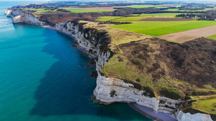 Aerial drone view of picturesque coastal limestone cliffs and the English Channel town of Etretat, France