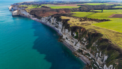 Aerial drone view of picturesque coastal limestone cliffs and the English Channel town of Etretat, France