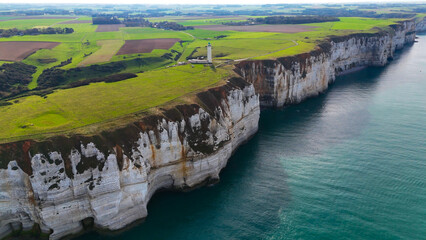 Aerial drone view of picturesque coastal limestone cliffs and the English Channel town of Etretat, France