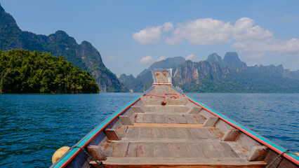 Serene boat ride on Cheow Lan Lake amidst stunning limestone cliffs in Khao Sok Thailand