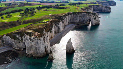 Aerial drone view of picturesque coastal limestone cliffs and the English Channel town of Etretat, France