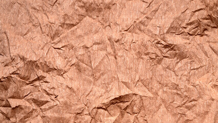 horizontal background of heavily crumpled copper colored crepe paper