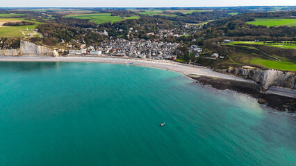 Fototapeta premium Aerial drone view of picturesque coastal limestone cliffs and the English Channel town of Etretat, France