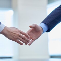 The picture shows two hands about to shake hands