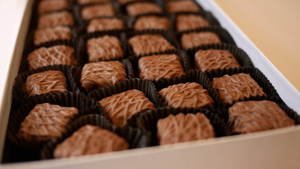Chocolates Spinning in Luxury Box over White
