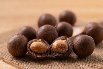 Macadamia nuts on brown background, Close up