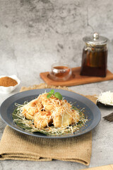 Fried Banana With Grated Cheese and Tea on Rustic Table