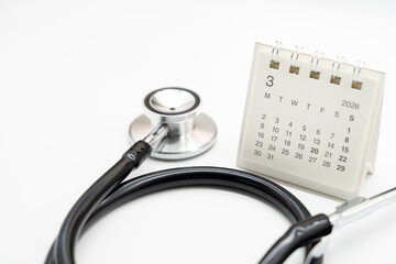 Doctor Appointment Schedule and Annual Health Checkup Reminder. desk calendar set to MARCH 2026. preventive medicine, healthcare planning, doctor visits, and timely examinations.