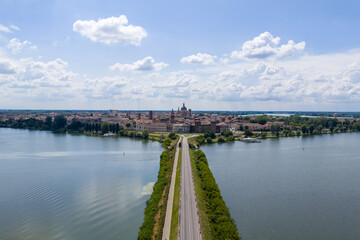 Obraz premium Aerial view of Mantua skyline and causeway across Lago di Mezzo - Mantua, Italy