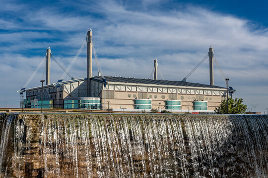 San Antonio, Texas, USA - December 2, 2025:  Exterior view of the San Antonio Alamodome, a multi-purpose stadium, with water feature in the foreground.
