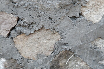 Texture of Rough Stone and Dark Gray Cement Mortar Wall