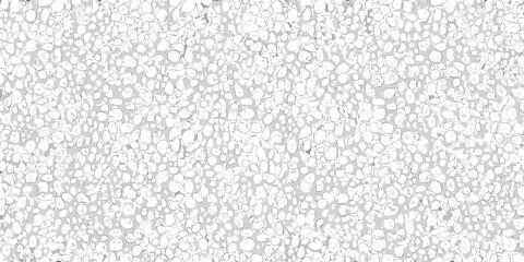 Close up view of a textured surface resembling small light colored pebbles