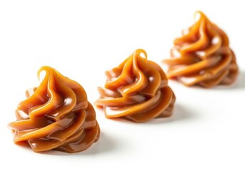 Three swirls of caramel sauce isolated on white background