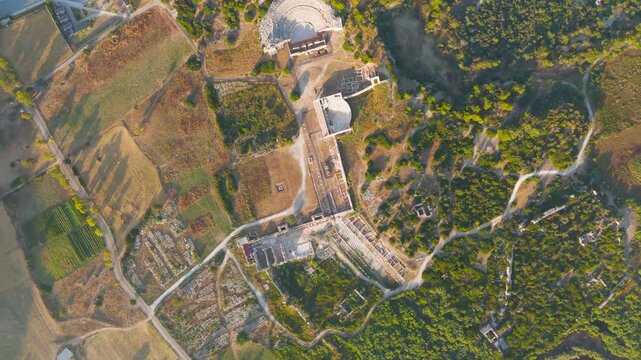 Gelemis, Turkey. Ancient Theatre, Colonnaded Street, Bouleuterion Parliament and Roman Baths of Vespasian at Kursunlu Tepecik Hill in clear summer morning. Aerial View, HEAD OVER SHOT