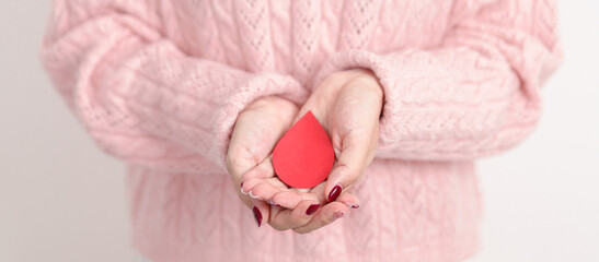 Adult woman with red Blood drop paper for concept of June World Blood Donor day, Donation, April Hemophilia awareness day, May Thalassemia Day, Anemia awareness, June Sickle Cell and Blood Disorders