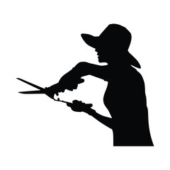 Woman Gardener Silhouette with Hat Pruning Plants using Small Scissors or Shears in Horticulture