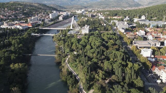 The Moraca river dominates the panorama of Podgorica, Montenegro.  Aerial drone video.
