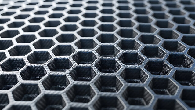 Black carbon fiber honeycomb structure with hexagonal cells in grid pattern material