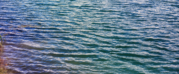 Water surface. The texture of the water. Waves on the lake in windy weather.