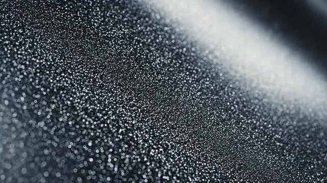 Abstract Water Droplets on Surface - A macro shot showcases numerous tiny water droplets scattered across a dark, reflective surface.