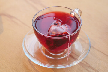 Hot tea in a clear cup on a wooden table