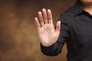 Stop hand gesture showing warning and protection concept.