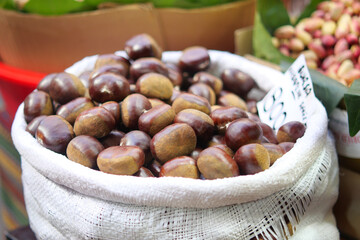 Fresh chestnuts in a market basket during autumn season