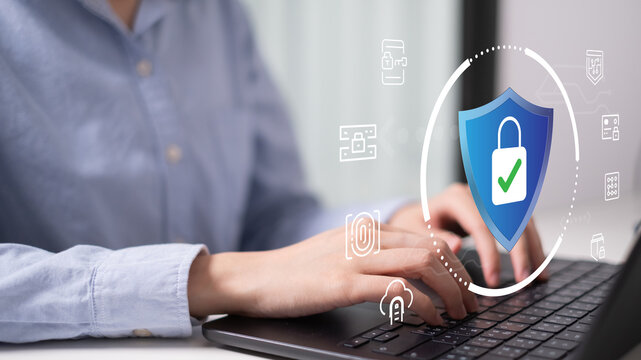 Businessman online digital remote working laptop computer with shield padlock lock password, cybersecurity and data information protection access firewall concept