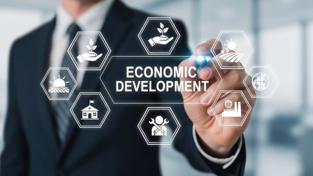 Businessman touching Economic Development on a virtual screen with various related icons.