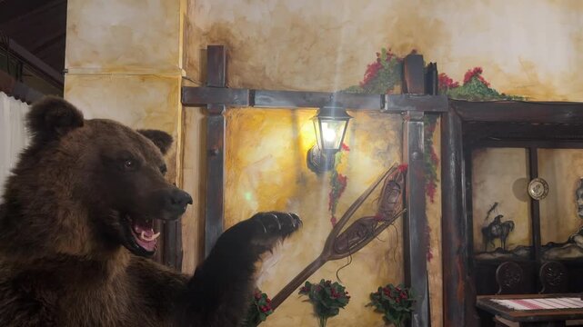 taxidermy bear in a rustic romanian restaurant interior with warm lantern light