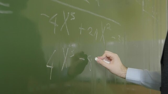 Teacher Hand Writing Polynomial Algebra Formula on School Blackboard
