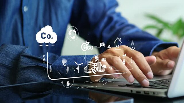 Businessman hand using a laptop with co2 icon on screen display, taking into account modern technologies and environmental safety. ESG environment social governance investment business concept.