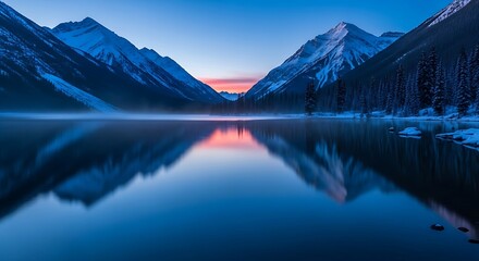 Tranquil mountain lake at dawn with snow-capped peaks and calm reflection