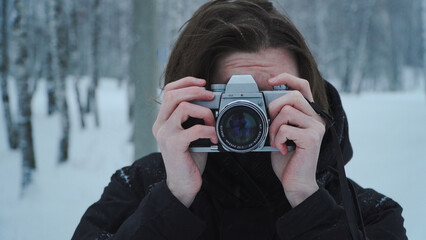 Man taking photo on vintage film camera