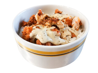 A delicious rice bowl featuring golden fried chicken drizzled with creamy sauce and herbs, served hot in a striped bowl.