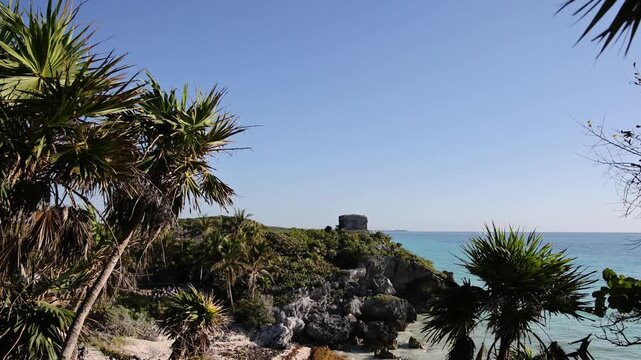 stunning beach view with palm trees (tropical palms) at tulum mexico (seaside historic mayan ruin site with temple pyramid on the coast) coastal travel paradise caribbean sea yucatan penisula palms 