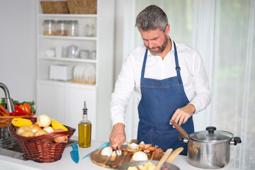 A chef cooking fresh vegetables. A man cooking a homemade meal. A cook cooking veggies for a healthy breakfast in kitchen. Chef in uniform cooking vegetables in a modern kitchen.