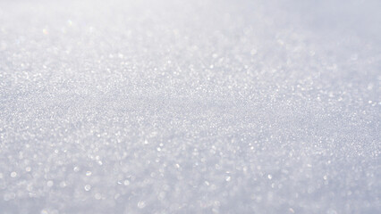 Snow background. Winter field with white snow texture. Winter background with snowy surface. Snowy pattern closeup. White background with snow texture.