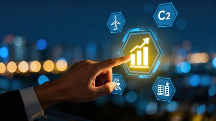 Hand interacting with digital holographic icons displaying growth chart, renewable energy, and technology symbols against city night backdrop