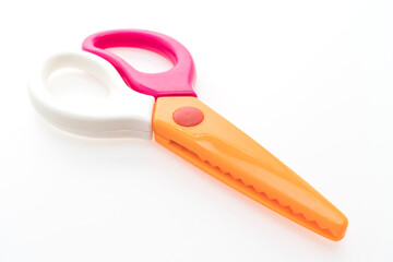 A pair of children s safety scissors with orange and pink handles