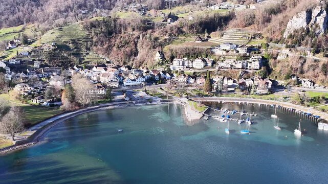sunlit walensee shoreline reveals clear water, quiet boats, and clustered village homes