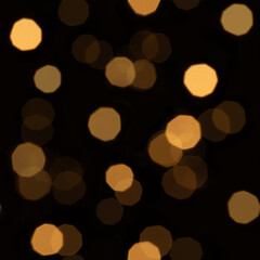 Seamless yellow bokeh lights pattern on dark background creating abstract festive night texture