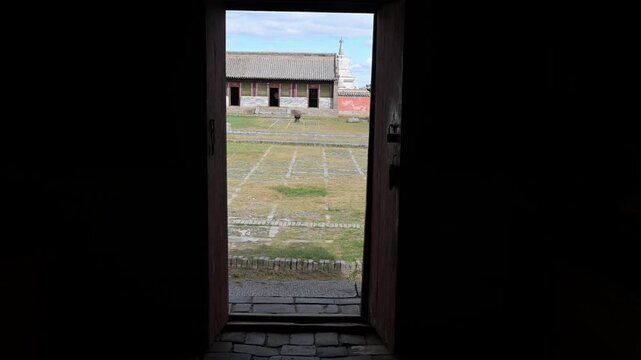 A historic shrine stands at Erdene Zuu, Mongolia's oldest monastery. The 16th-century pavilion displays ornate green tiles and traditional design, preserving ancient religious artistry.