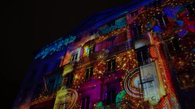 Colorful thematic digital art projected on building facades during F&ecirc;te des Lumi&egrave;res festival in Lyon, France