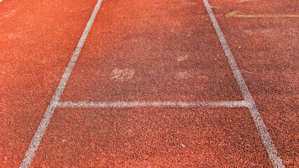 Fototapeta premium Close up shot of a red running track with white lane lines, suggesting competition, speed, and dedication