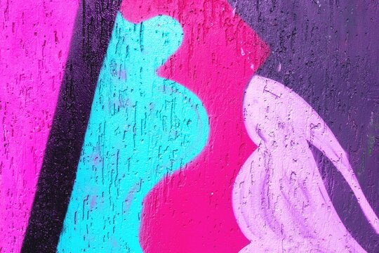 Vibrant graffiti with bold pink, purple, teal. Offers retro 90s, Y2K style, liquid forms. Urban mural, street art, colorful backdrop, digital media.