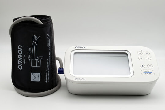 Bologna - Iytaly - December 9, 2025: Omron x7 smart afib automatic upper arm blood pressure monitor with cuff isolated on white background.