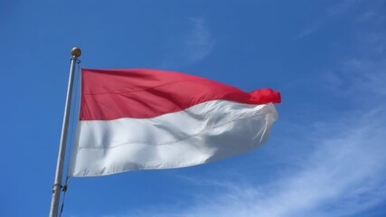 Majestic Indonesian Flag Waving in Blue Sky - Merah Putih National Pride
