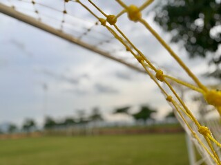 Close-up view of a football goal net with shallow depth of field, sports concept background with...