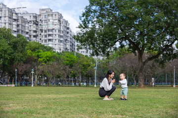 Fototapeta premium Mother enjoying playtime with son at park